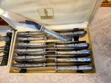 a lot of knives in a box with a knife in it
