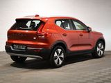 the rear end of a red volvo suv parked in a garage