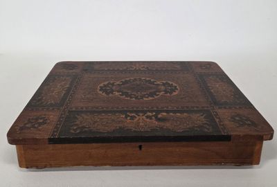 an old wooden box with a decorative design on it