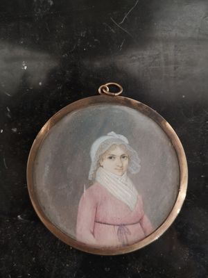 an old picture of a woman in a pink dress and a white hat