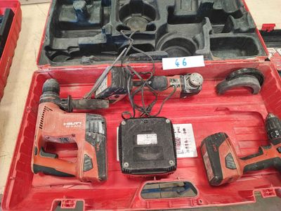 a red tool case with tools in it on a table