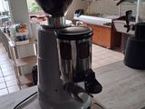 a coffee grinder sitting on top of a counter in a kitchen
