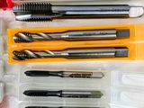 many different types of drill bits in a plastic box