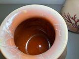 a vase that has a brown liquid inside of it