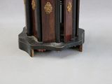 a clock that is sitting on a stand on a table