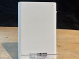 a white power bank sitting on a table next to a charger