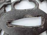 a close up of a metal object on a white surface