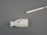 a white toothbrush and a white tube on a table