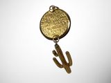 a close up of a metal object with a cactus on it