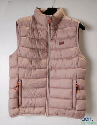 the vest is hanging on a hanger on the wall
