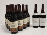 six bottles of wine are lined up in a row on a table