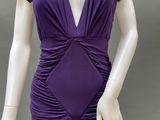 an image of a mannequin wearing a purple dress with ruffles