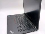 a laptop with a black keyboard sitting on a white surface