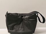 a black purse that is sitting on a table