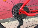 a close up of a red bike with a chain on it