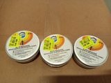 trois tubes de dentifrice posés sur une boîte en carton