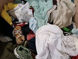 a cardboard box filled with clothes and other items