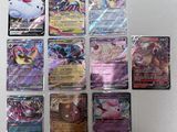 several pokemon cards sitting on top of each other on a table