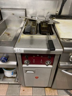 a kitchen with two stoves and a dishwasher in it