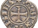 une pièce d'argent sur laquelle est gravée une croix