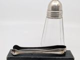 silver plated salt and pepper shaker on a black box