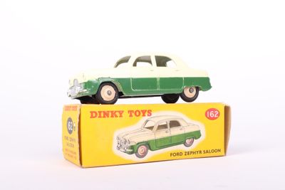 a green and white toy car sitting on top of a box