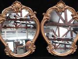 two mirrors that are sitting on a black surface