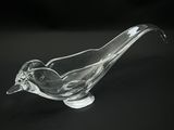 a glass bird that is sitting on top of a table