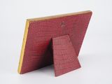 a close up of a red picture frame on a white background
