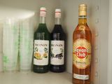 bottles of liquor are lined up on a shelf in a refrigerator