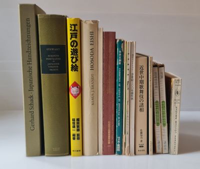 a lot of books that are stacked up on a table