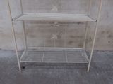 a white metal shelf with two shelves on it