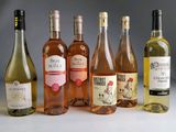 several bottles of wine are lined up on a table
