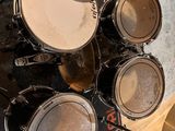 a close up of a drum set on a wooden floor