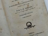 an old book that is open on a table