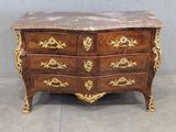 a marble top chest of drawers with gold decoration