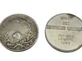 a close up of a coin with a bird on it