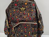 leopard print backpack with gold zippers and zipper closures