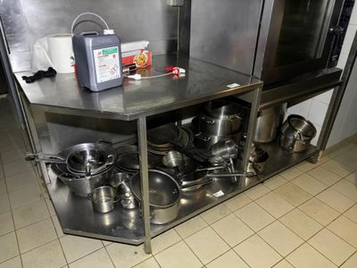 pots and pans sitting on a stainless steel counter