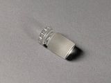 an image of a small silver object on a gray surface