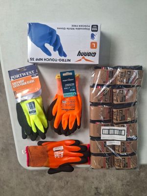 a box of gloves, gloves, gloves, and other items on a table