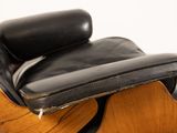 an image of a black leather lounge chair and ottoman on a white background
