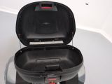 a black suitcase sitting on top of a gray suitcase