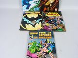 a group of comic books sitting on top of a white table