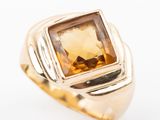 an image of a gold ring with a citrine stone in the center