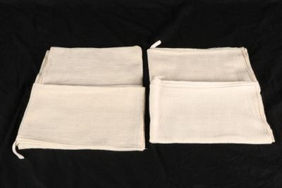 two white cloth bags on a black background