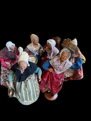 many figurines of people dressed in traditional clothing
