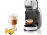 an image of a coffee machine with a cup of coffee next to it