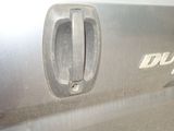 a close up of a car door handle with a logo on it