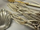 a lot of silverware on a table with spoons and forks